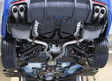 The underside of a car on the hoist, showing the full exhaust system
