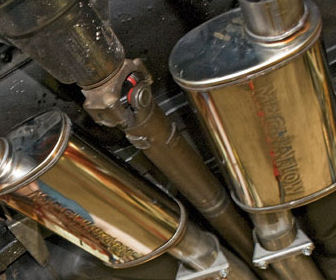 Mufflers fitted under a car in the Albion workshop