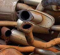 A pile of old rusted exhaust parts