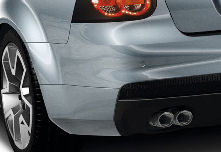 Twin exhaust tips on a silver car