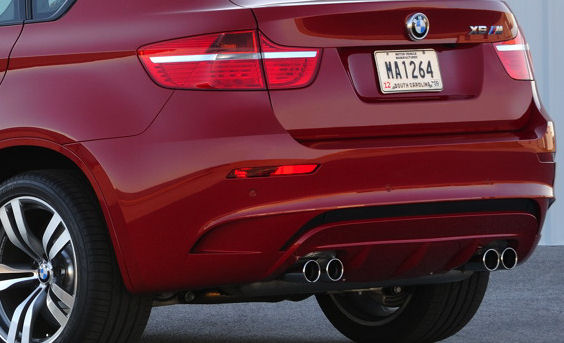 Twin exhaust outlets on a red SUV