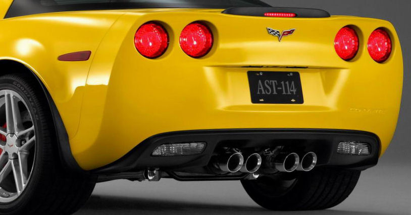 Quad exhaust tips on a yellow sports car